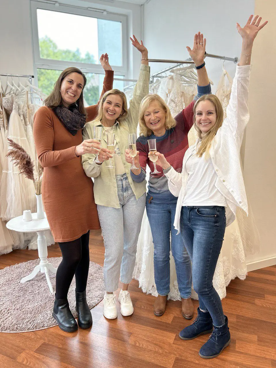 Strahlende Kundin feiert mit Sekt im Brautmodengeschäft in Velbert. Ob günstige Brautkleider aus dem Outlet oder exklusive Standesamt-Mode – hier findet jede Braut ihren perfekten Look.